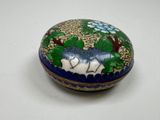 a small blue and white box with flowers on it