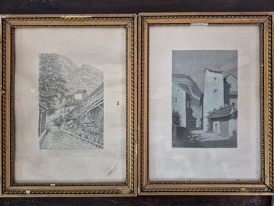 two framed pictures of a building and a train on a wall