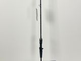 a close up of a black umbrella on a stand in front of a white wall