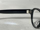 black glasses with clear lenses on a white surface