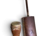 two drums and a wooden stick on a white surface