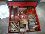 une boîte à outils rouge avec des outils sur le sol
