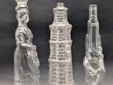 three clear glass vases sitting next to each other on a table