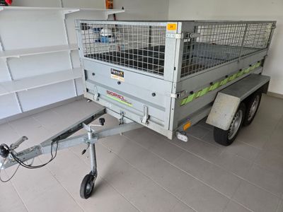 a trailer with a cage on the back of it