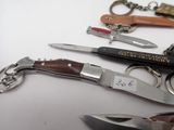 many different types of knives on a white table