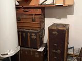 many suitcases and boxes stacked on top of each other in a room
