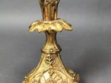 an antique brass candelab with flowers and leaves on a stand