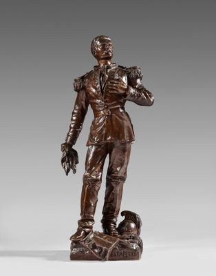 a bronze statue of a man with a dog on a rock