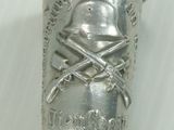 a silver cup on top of a cane with a skull and crossbones on it