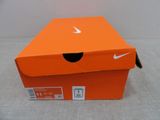 an orange nike shoe box sitting on top of a table
