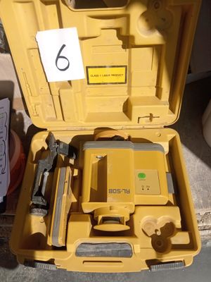 a yellow tool box with tools in it on the ground