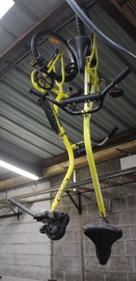 a bike hanging from the ceiling in a garage