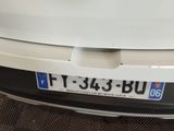 a close up of a white car with a license plate on it