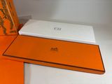 an orange and white box sitting on top of a table next to an orange and white box