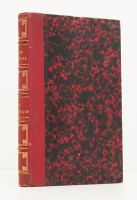 un livre rouge et noir posé sur une table blanche
