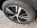 a close up of a car tire on a dirt road
