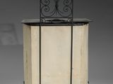 a small cabinet with a black top and a metal top