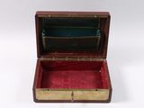 an old wooden box with a red lining inside of it