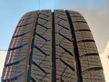 a close up of a tire on a white surface with a blue sky in the background