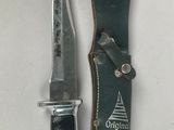 an image of a knife and sheath on a white surface