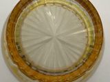 a glass plate with a yellow rim on a white table