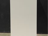 a tall white cabinet in a room with a black wall
