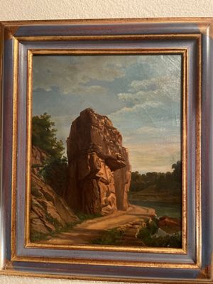 peinture sur le mur d'une pièce où l'on voit un homme assis sur un rocher