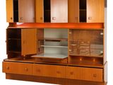a large wooden cabinet with drawers and shelves on it