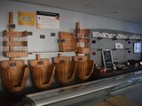 many baskets hanging on the wall behind the counter