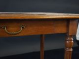 a wooden table with a drawer on top of it