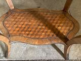 a wooden table with a checkered pattern on top of it