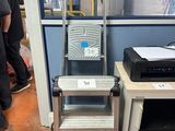 a ladder that is next to a printer on a table