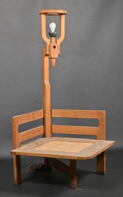 a wooden bench with a lamp on top of it