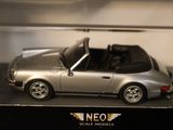 a silver toy car in a clear box on a table