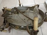 a large metal bowl with a candle holder on the floor