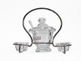 a glass teapot and two cups on a stand