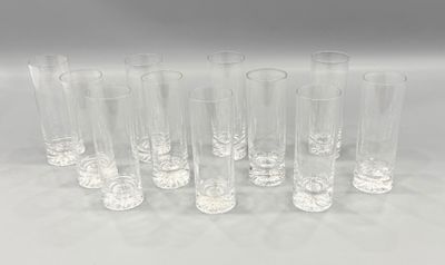 six clear glass vases lined up in a row on a white surface