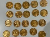 a lot of gold coins sitting on a white surface