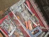 a suitcase full of tools sitting on top of a pallet