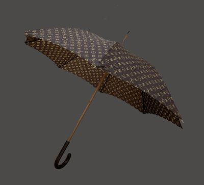a brown and white umbrella with a black handle