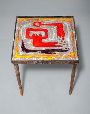 an image of a small table with a painting on top of it