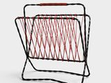 a black and red wire magazine rack with a red handle