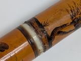 a wooden stick with a picture of a deer and a bear on it