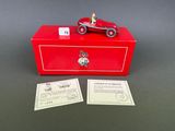 a red box with a toy car on top of it