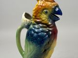 a colorful bird that is sitting on top of a cup
