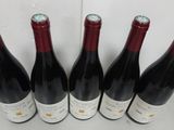 six bottles of wine are lined up in a row