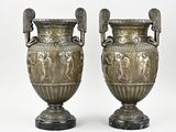 paire de vases anciens en argent, munis d'anses et de poignées, posés sur des socles en marbre