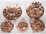 six pieces of copperware including a cake pan, a cake pan, and a cake pan