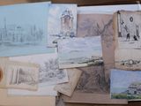 many different types of drawings displayed on a table