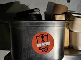une casserole en métal sur laquelle est collé un autocollant, dans une cuisine